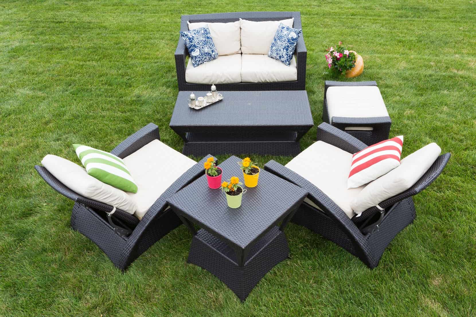 5 Benefits Of Reclining Garden Furniture. Cozy dark rattan furniture with a sofa and the table, and soft pillows