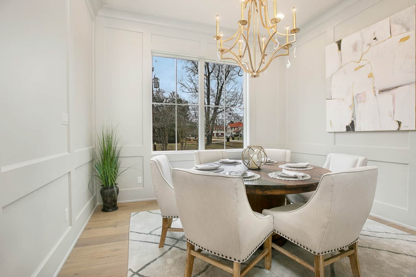 5 Steps to DIY Designing on a Budget. Lovely classic dining room decoration with textured walls, mild grey color palette and solid round table in the center