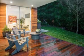 9 Ways To Liven Up Your Patio. Dark lacquered patio deck with gray wooden chairs and a small round table