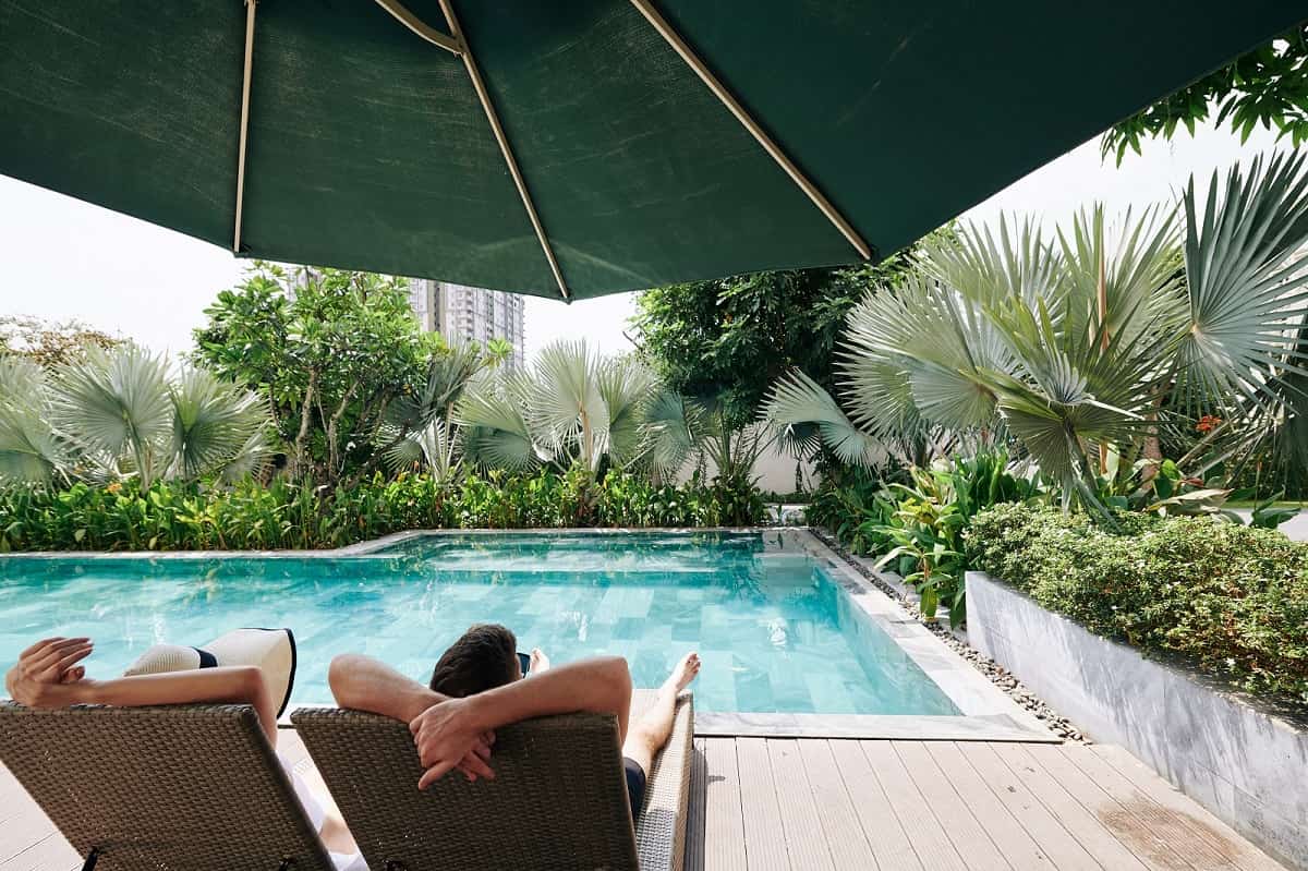 6 Pool Design Tips If You Have A Small Backyard. Summer chilling under the large green beach umbrella
