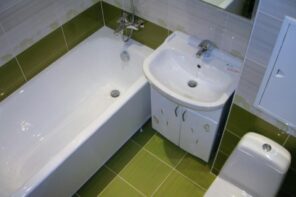 7 Worst Things You Can Do During a Bathroom Remodel Project. Green and white color palette for the small room full of appliances