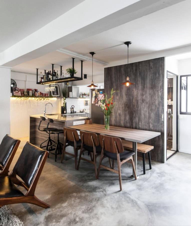 Reasons Why Concrete is the Best Flooring Alternative to Your Homes. Dark wooden interior wall near the dining zone with large table and retro tables