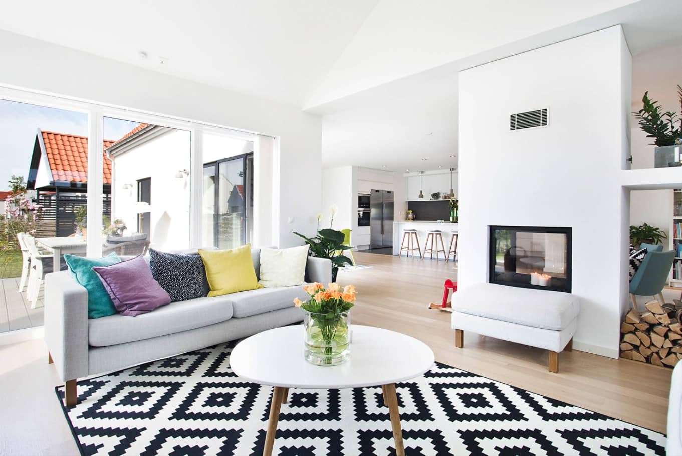 How to Create a Theme in Your Home. Great living room in casual/Scandinavian style with black and white rug and the the fireplace