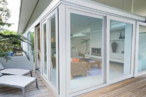 What are the Benefits of UPVC Windows and Doors? Glazed summer house with wooden deck around the perimeter