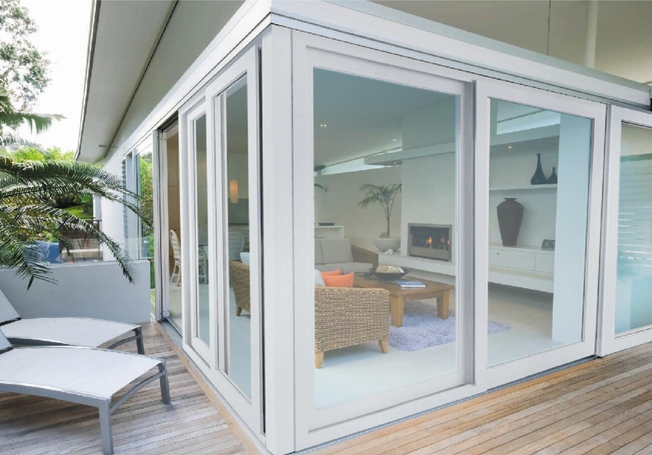 What are the Benefits of UPVC Windows and Doors? Glazed summer house with wooden deck around the perimeter