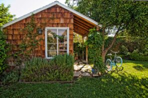 The Best Way to Clean Your Garden Shed. Colorful picture of the outdoor shed with planked facade and gable roof