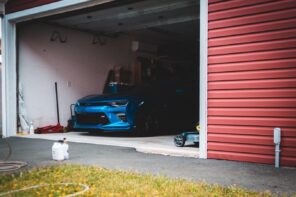 Perfect Additions For Your Garage To Make It More Functional. Sport car in the garage with sectional doors