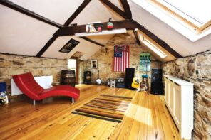 How to Turn a Long-Neglected Loft into a Music Room. Nice looking bright chalet attic with natural hardwood floor and red chaise lounge