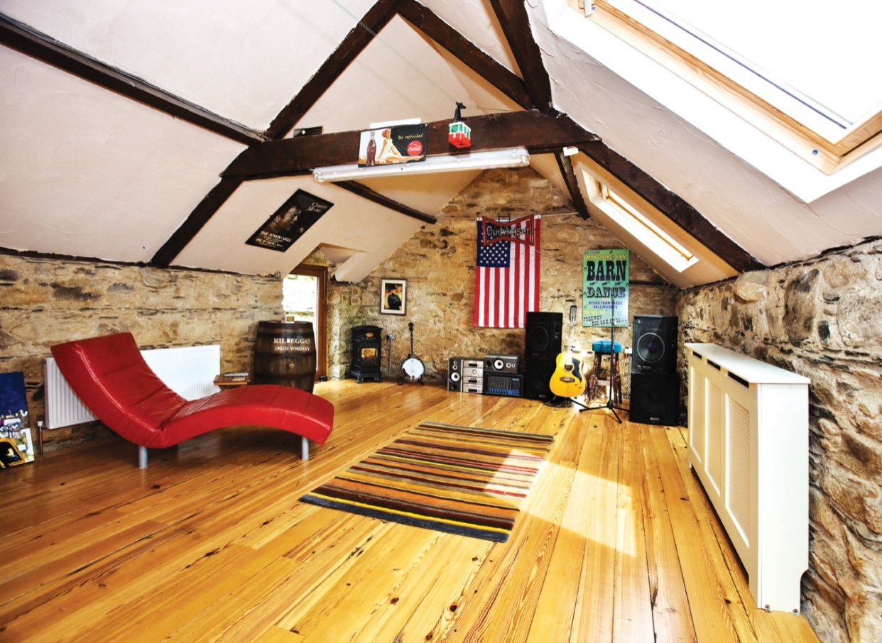 How to Turn a Long-Neglected Loft into a Music Room. Nice looking bright chalet attic with natural hardwood floor and red chaise lounge