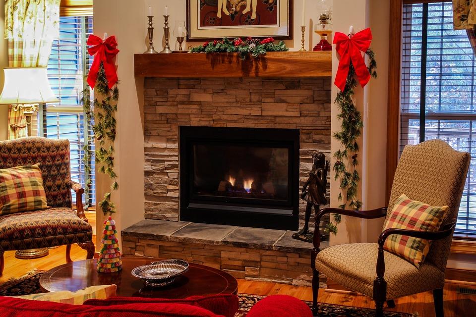 7 Ways To Give Your Home A Warm And Comfy Atmosphere. Christmas decorated fireplace with wooden mantelshelf and stone finishing
