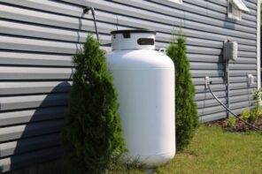 How to Hide That Ugly Propane Tank. Masterfully hidden tank among the shurbs at the fence
