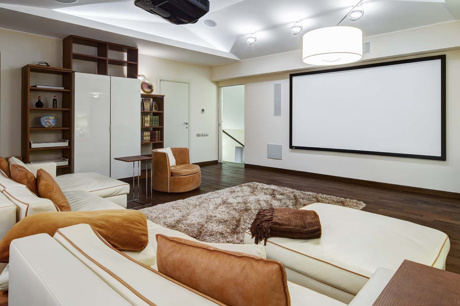 4 Makeover Tips For Creating The Perfect Home Theater Design. White colored interior in casual style with brown floor and furniture inclusions