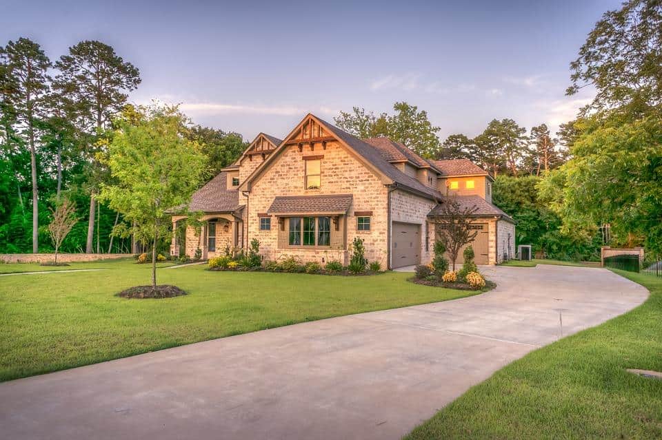 6 Ways to Make the Exterior of Your House Look Better. Nice stone cladded house with dark roof