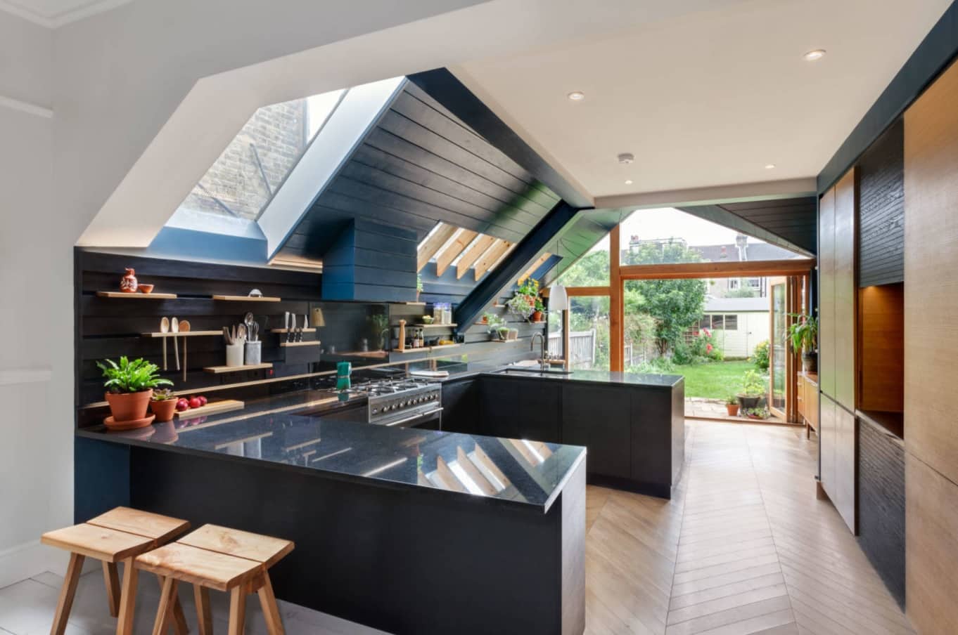 The Benefits Of Renovating Or Extending A Home. Dark color theme in the modern styled summer kitchen