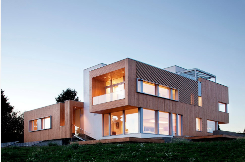 Wooden design of the high-tech house with panoramic windows and box forms of the stories