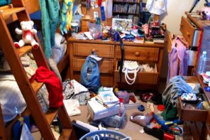 It’s Time to Let Go. Learn How to Get Rid of Clutter Fast! Stuffed and littery dorm room with bunk bed and old wooden dresser