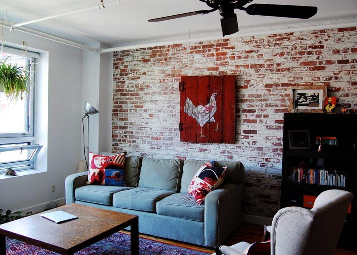 Brick Wall in the Living Room Stylish Interior. Simple loft design with a cloth poster