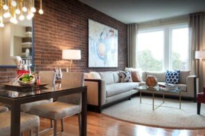 Brick Wall in the Living Room Stylish Interior. Large artwork at the accent wall