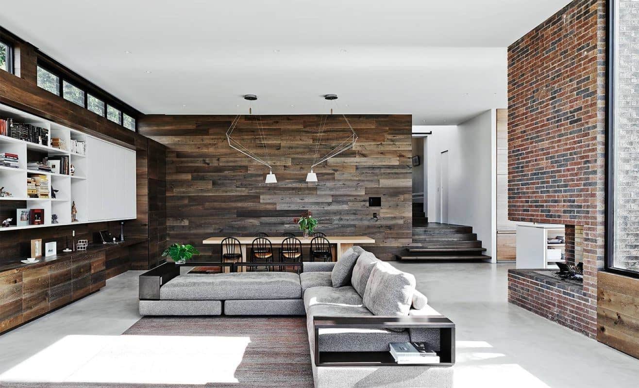 Dark wooden planks for accent wall on the large living room with huge gray corner sofa
