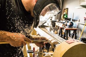 Want To Get Into Woodworking? Here's Some Helpful Advice. The worker at the lathe in a transparent mask