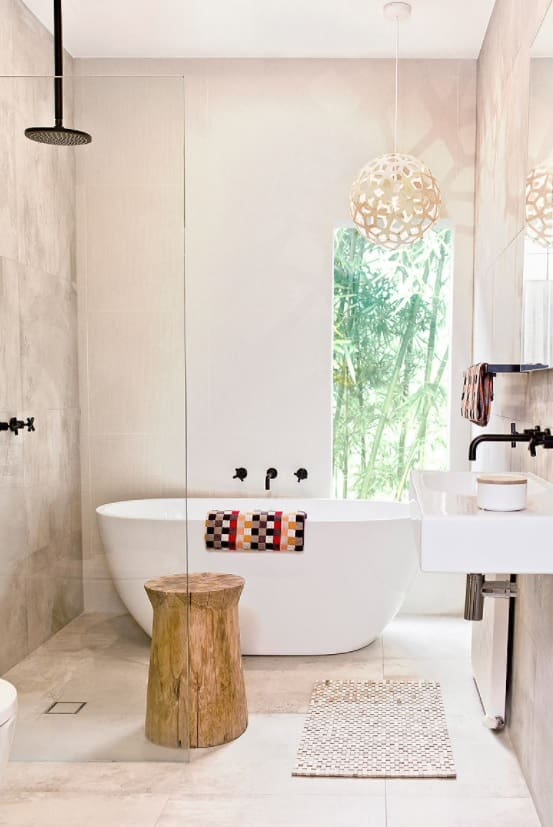How to Use Pendant Lights at Home. Light bathroom with modern exotic lamp and wooden stool in the minimalistic interior