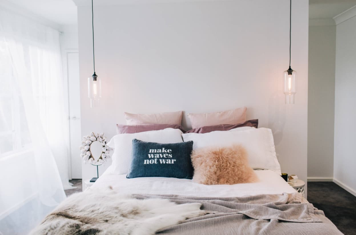 How to Use Pendant Lights at Home. Black cord lamps over the bed of the Scandi bedroom 