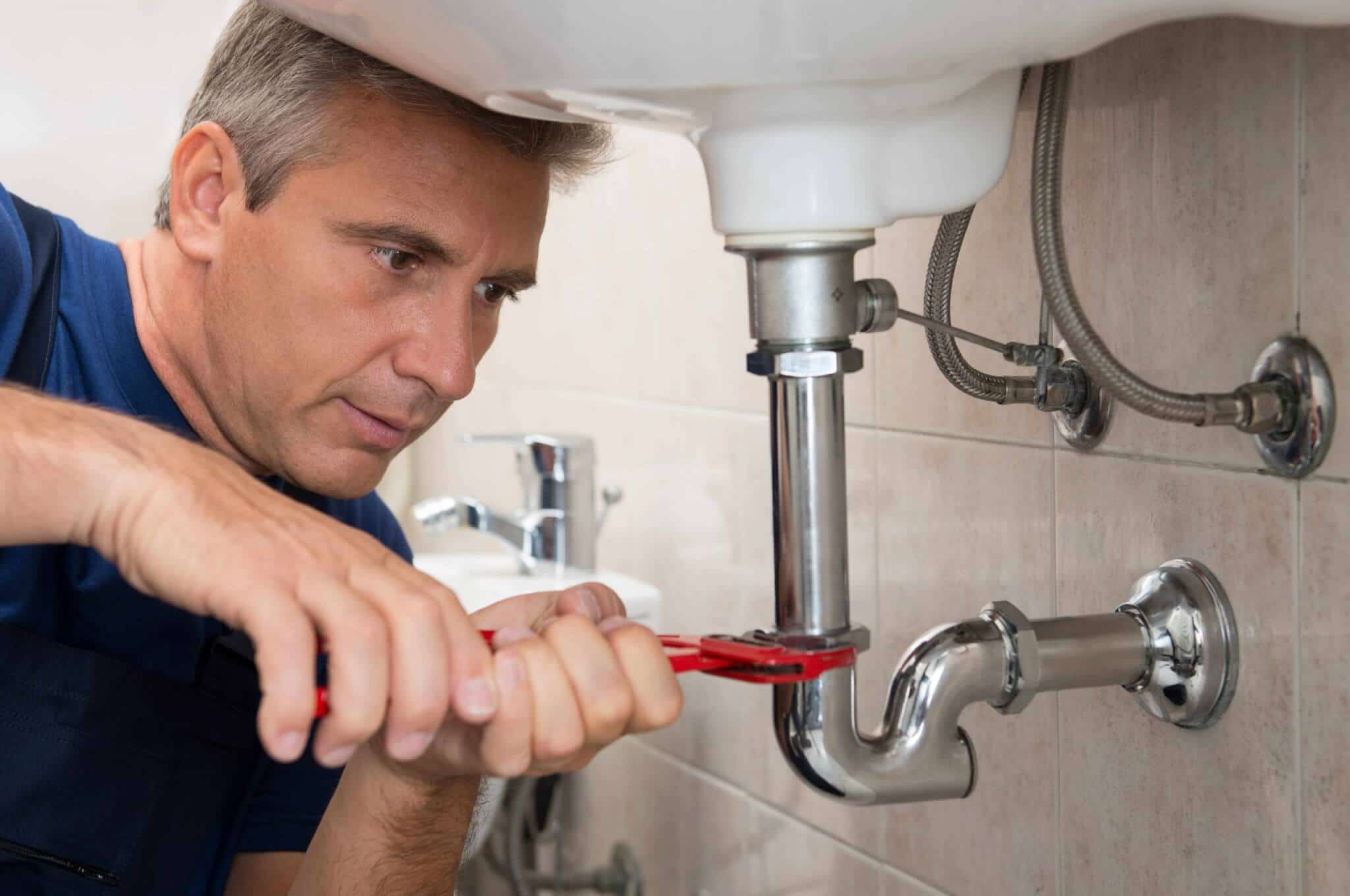 How Does a Plumber Fix Drain Clogging? Disassembling the sink by a professional