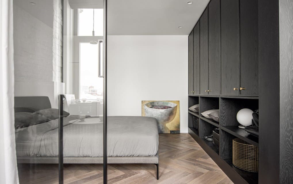 Tiny 100 Square Feet Bedroom Effective and Laconic Design Ideas. Contemporary minimalism with dark gray wooden furniture and platform bed separated with glass partition