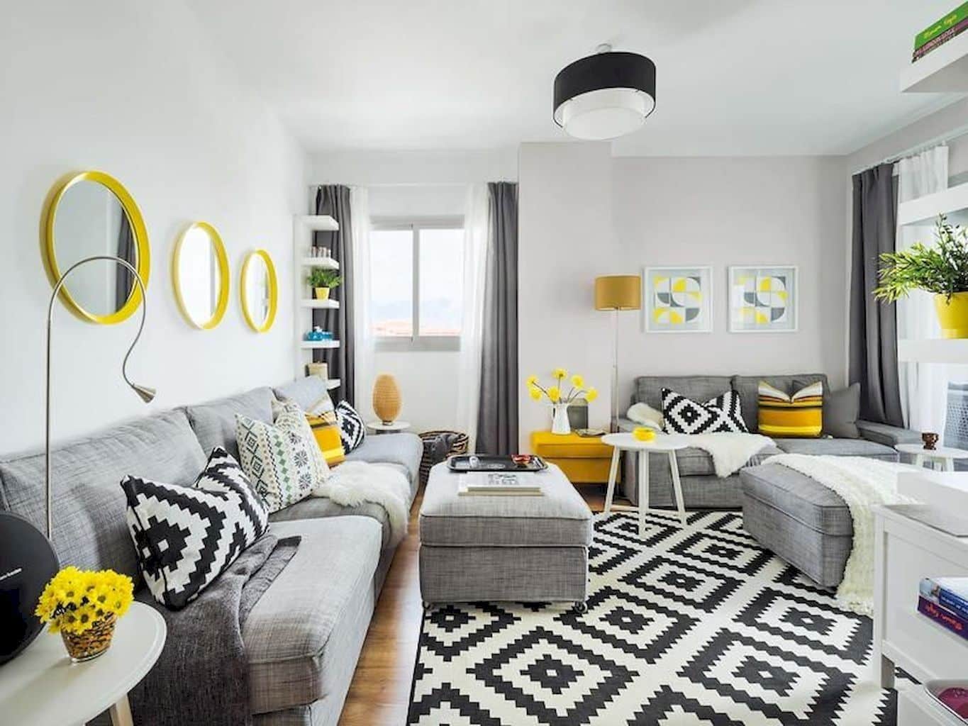 Linear and square patterns on the rug and pillows for gray colored living with slight yellow accent in the form of mirrors