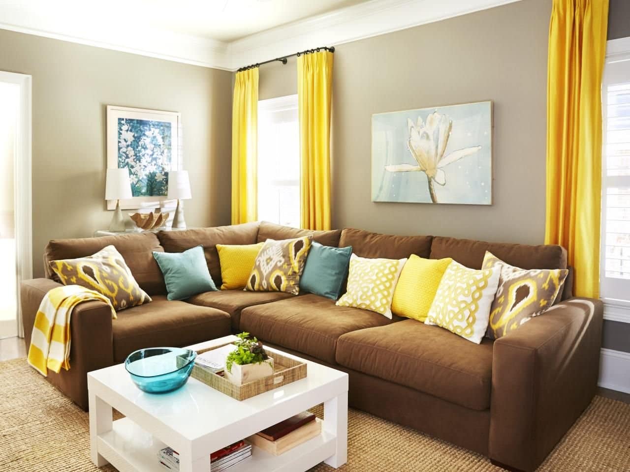 Brown sofa in the neutral gray living room with yellow curtains
