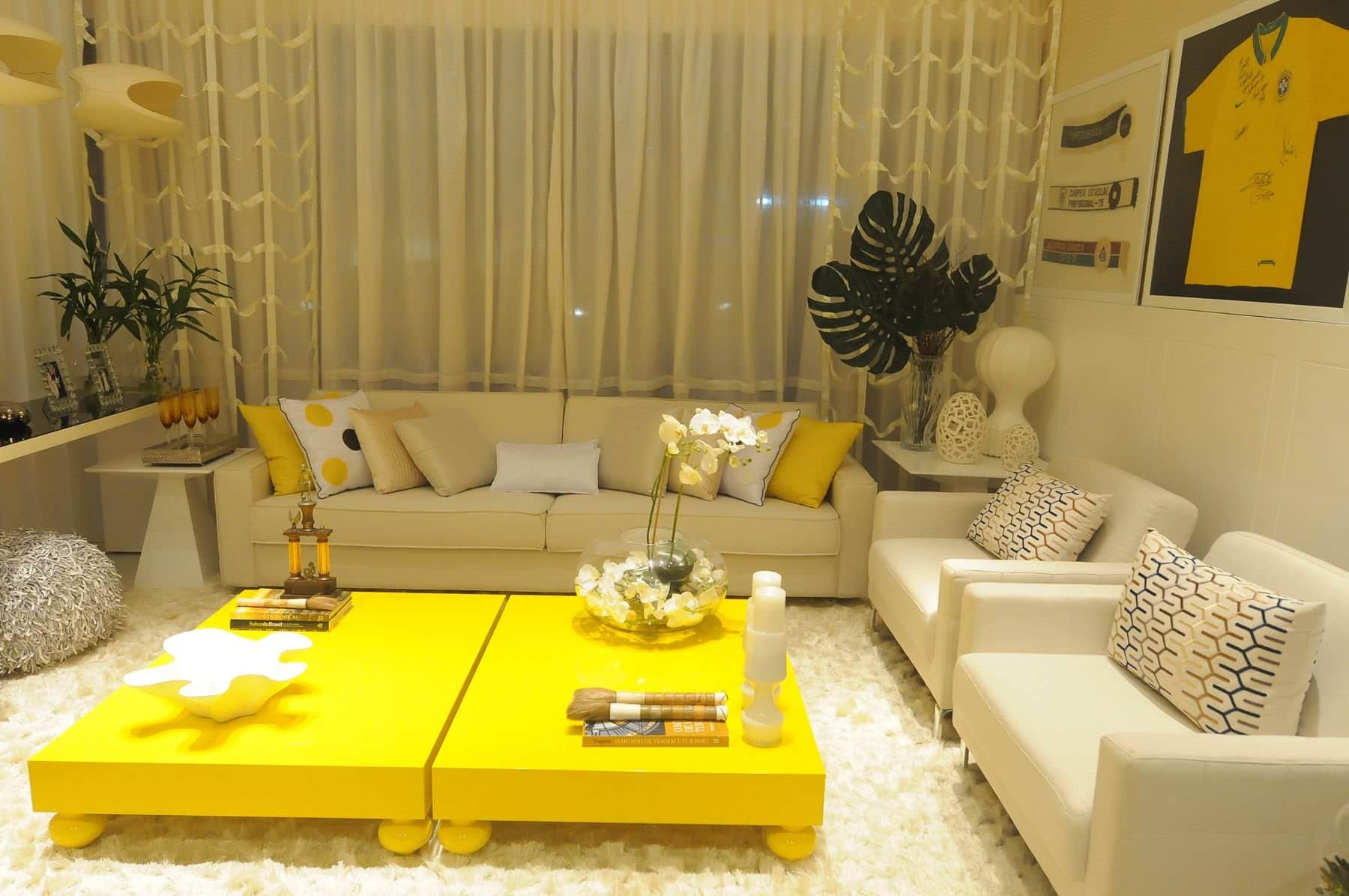 Unusual low yellow coffee tables for a large living zone with beige sofa and armchairs