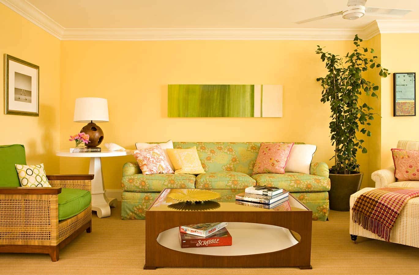 Yellow accent wall and green sofa