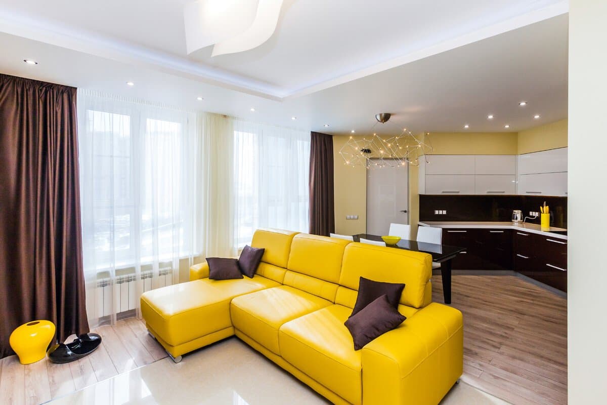 Bright Yellow Living Room Interior Decoration and Design Ideas. Large modular corner sofa as an accent for pastel colored interior