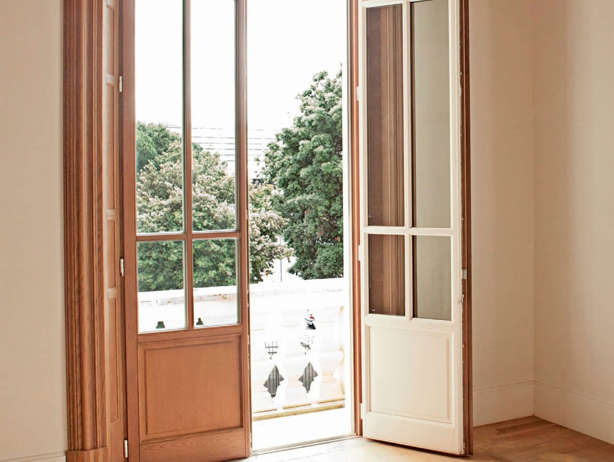 Choosing the Balcony Doors: Construction, Design, and Color. Wooden door black with large sash glass
