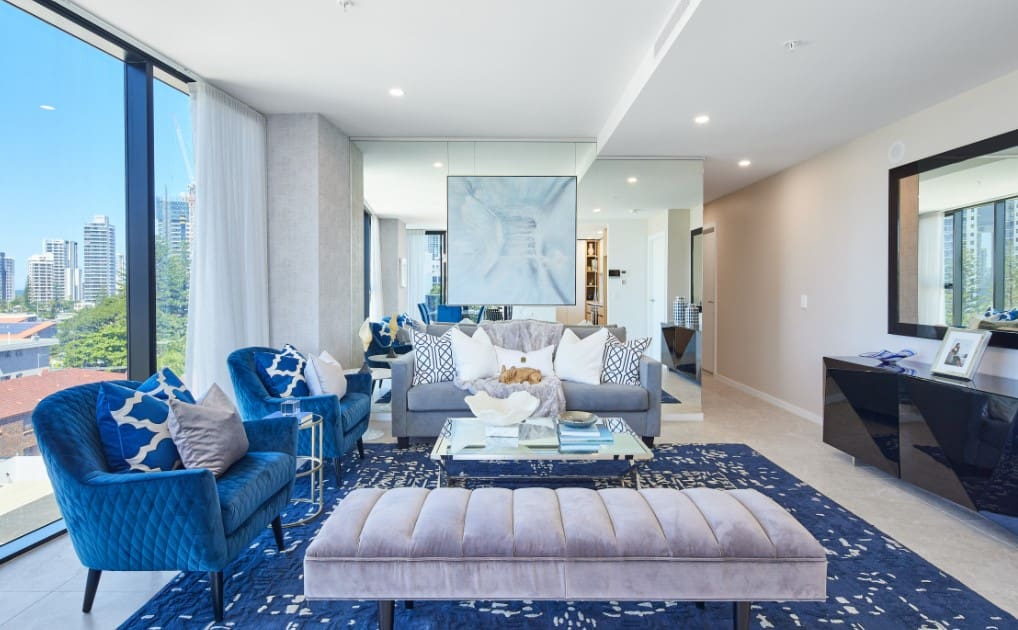 Living Room Interior 2022: Fashionable Design Trends & Ideas. Unusual aquamarine interior with quilted ottoman