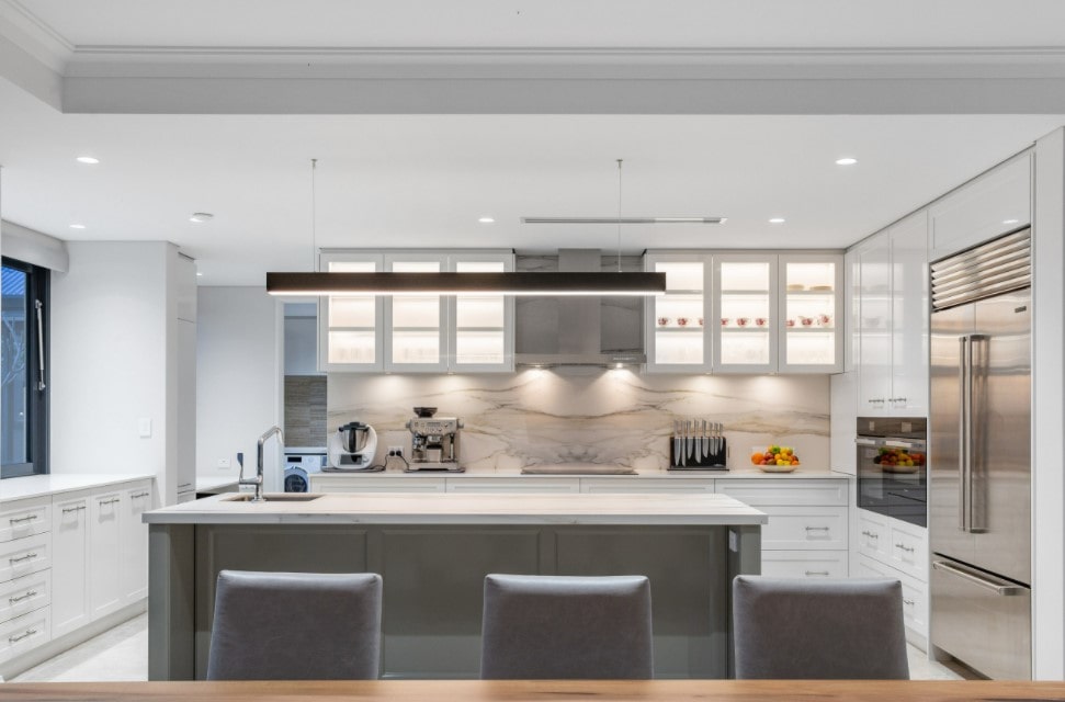 Modern minimalistic kitchen in white with smooth surfaces and light gray furniture
