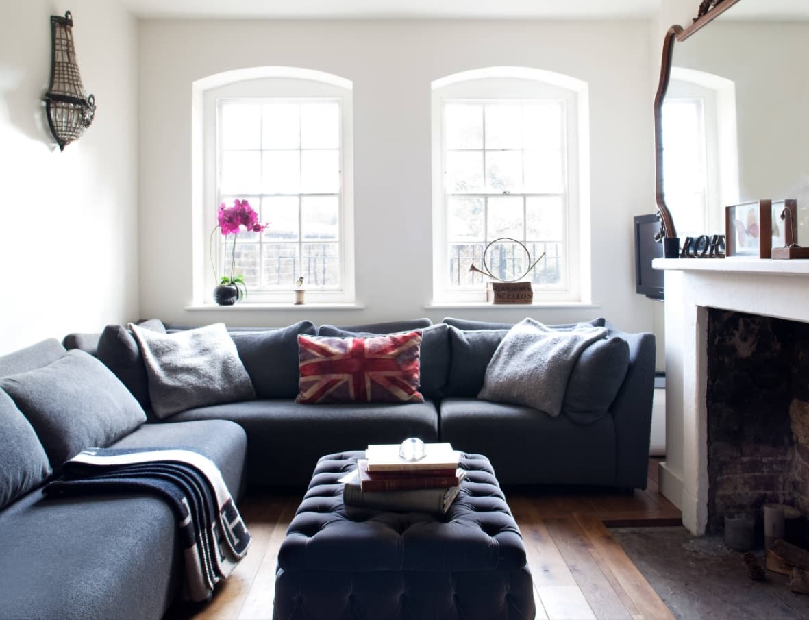 5 Easy Ways To Refresh Your Living Room Without Breaking the Bank. dark blue furniture for pastel white interior with cushions and blanket to add to the atmosphere