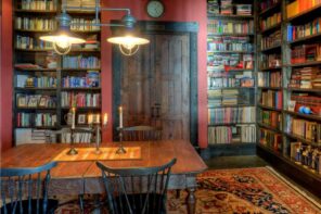 Expert Tips for Organizing Your Own Home Library. Red and black color palette in Classic style with large Arabic carpet and dark wooden chairs