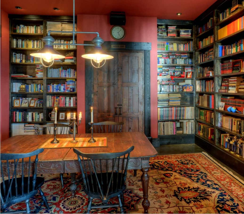 Expert Tips for Organizing Your Own Home Library. Red and black color palette in Classic style with large Arabic carpet and dark wooden chairs