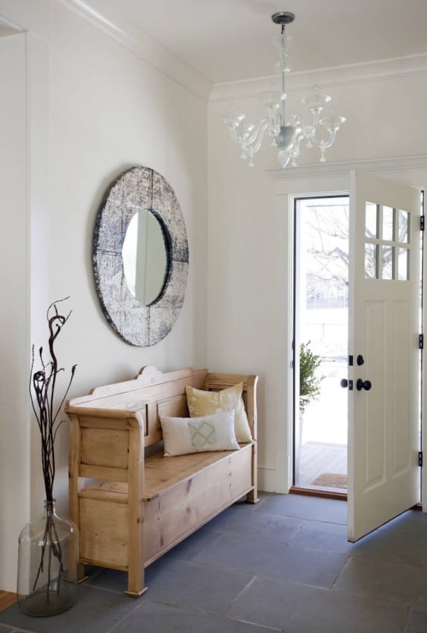 4 Ways to Create a Beautiful and Functional Entryway. Round mirror in solid wooden frame and contrasting light wooden bench for pastel white classic entryway