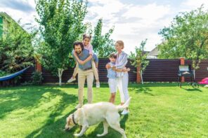 Is Having a Big Yard Worth It? The family with kids and the dog at the spacious trimmed garden