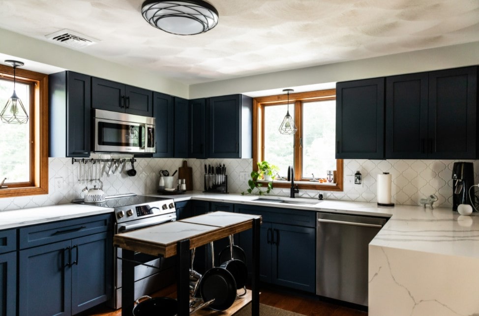 Dark blue kitchen cabinets and transforming island for simple and functional interior