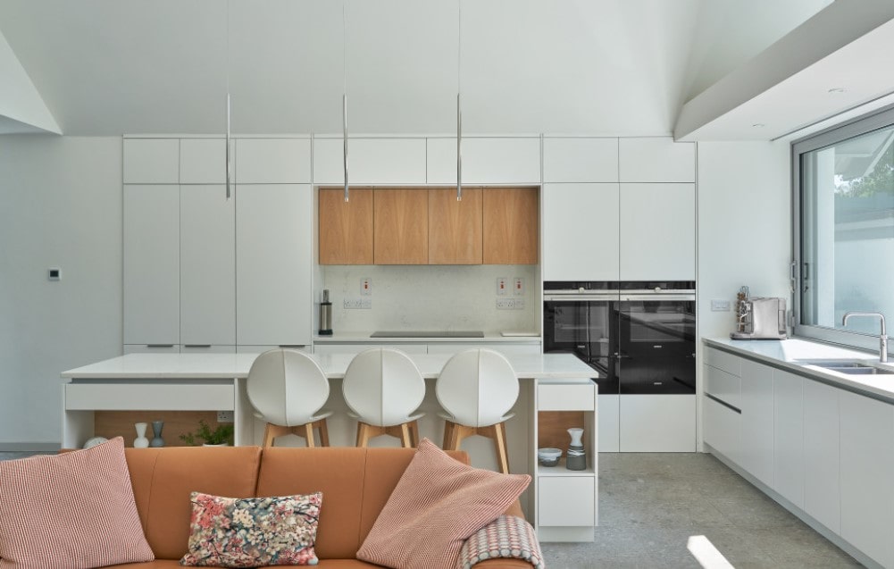Totally white kitchen interior with slight natural wood inclusion 