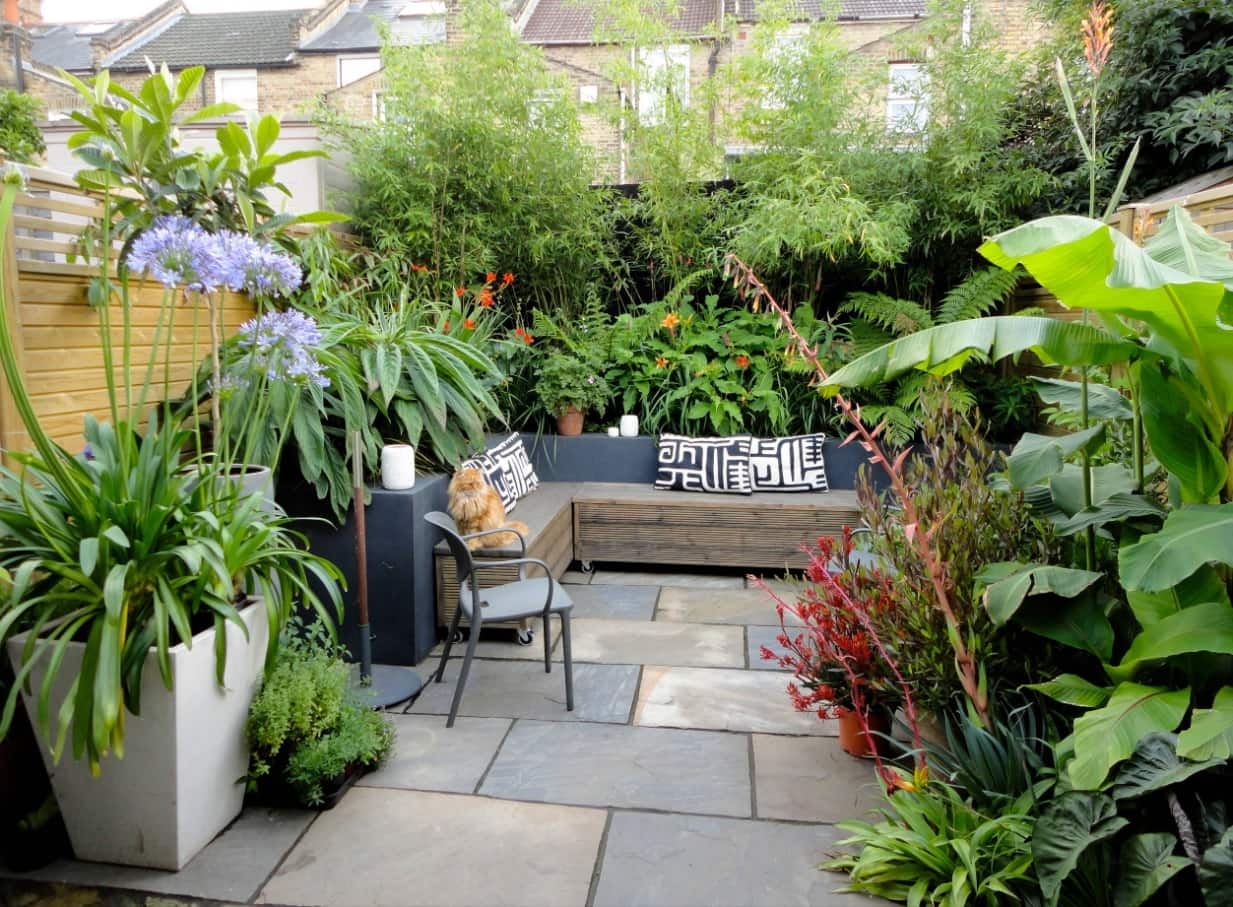 How to Make the Most Out of Your Garden. Nice patio zone with large stone tile and cozy furniture with blankets
