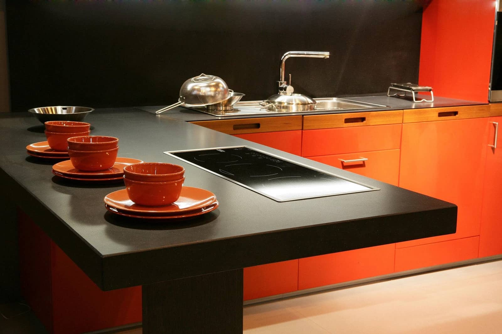 Silestone: The Up and Coming Worktop Material. Black and orange ultramodern kitchen theme in exquisite brutal style