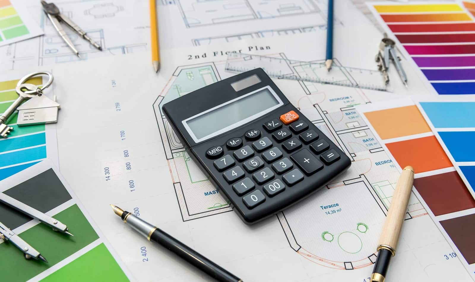 4 Tips for Sticking to Your Renovation Budget. The calculations and the paper floor plan on the table