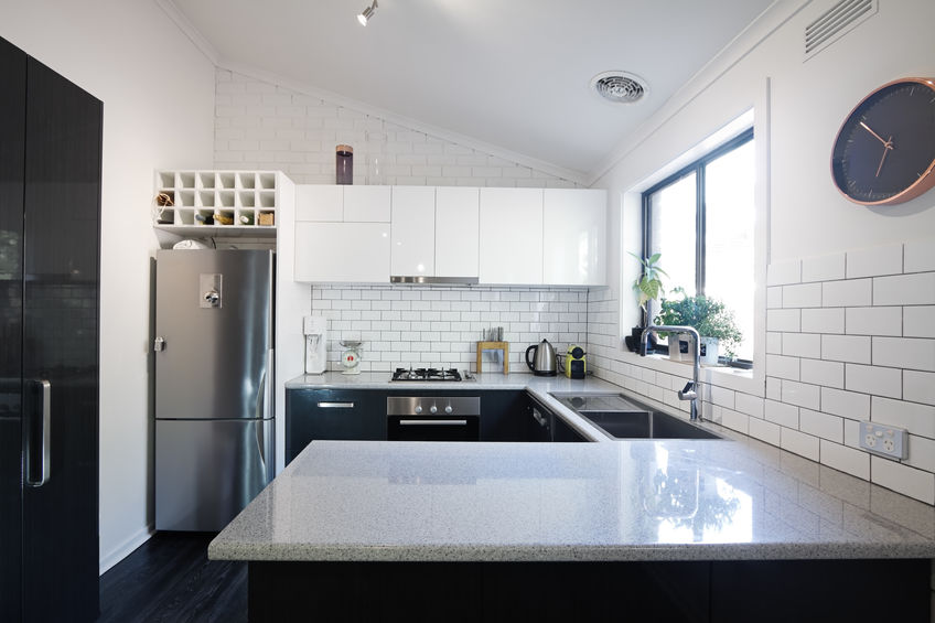 The Advantages of Using a Tile Paint for a Home Renovation. Casual kitchen in black and white with the sink under the window