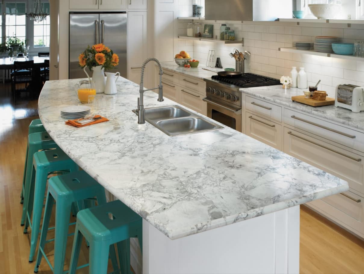 How Long Do Laminate Countertops Last. White Caesarstone with gray streaks, double sink and green plastic chairs at the kitchen island
