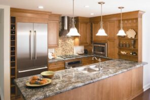 How Long Do Laminate Countertops Last. Wooden trimmed kitchen with faux marble countertop and classic tap