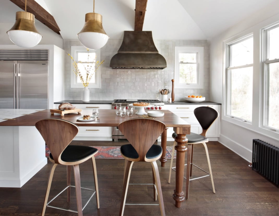 How To Design An Eclectic Kitchen For Your Next Remodel. White interior with dark wooden chairs and extractor hood
